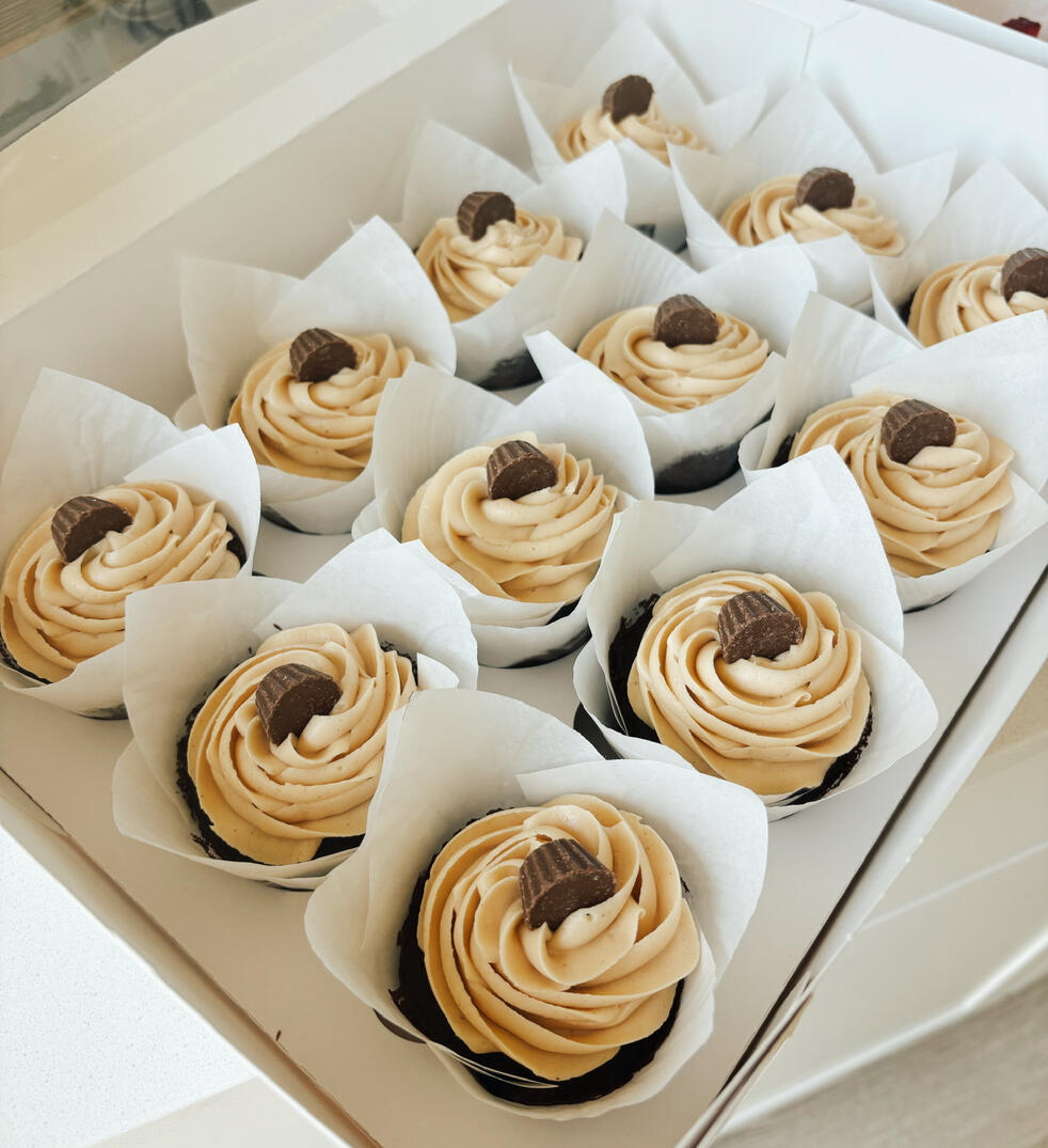 Professionally arranged peanut butter cupcakes in box